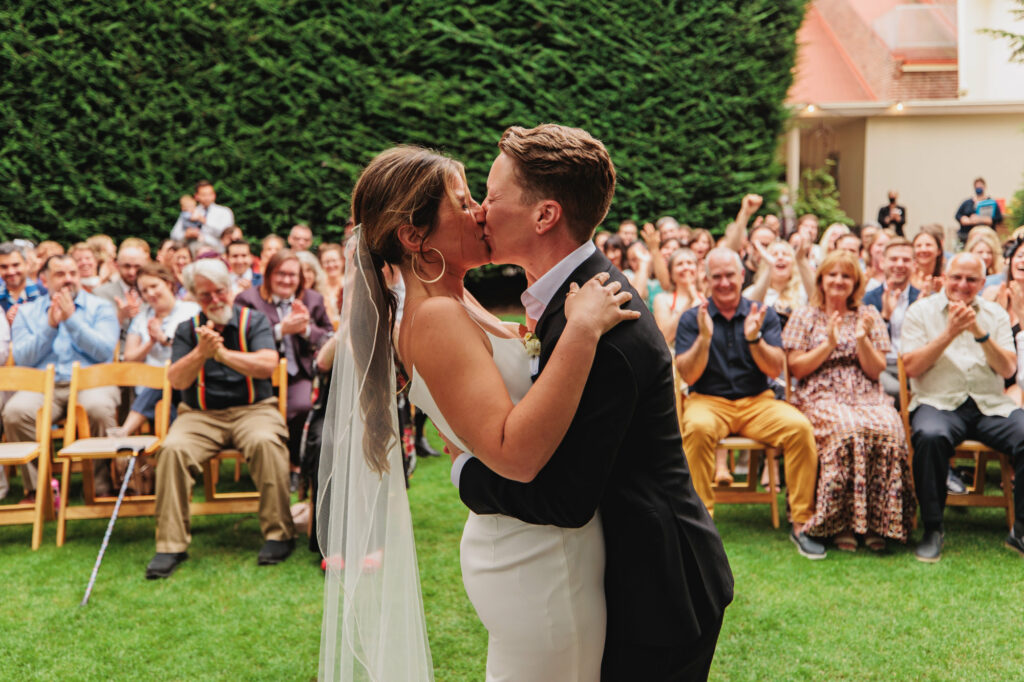 two brides kiss at end of wedding ceremony