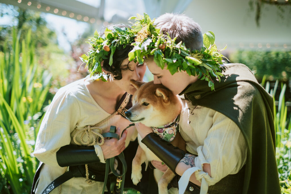 queer couple in flower crowns with their dog