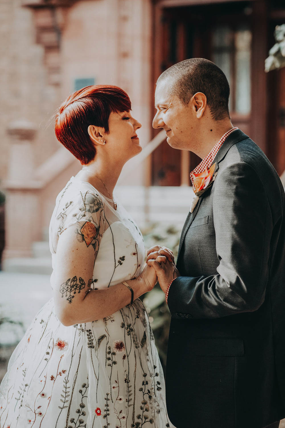 bride and groom smiling at each other in their wedding attire