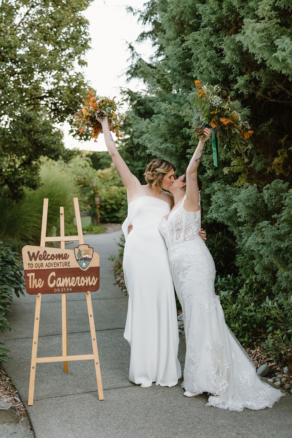 brides standing together at forest themed wedding, holding bouquets