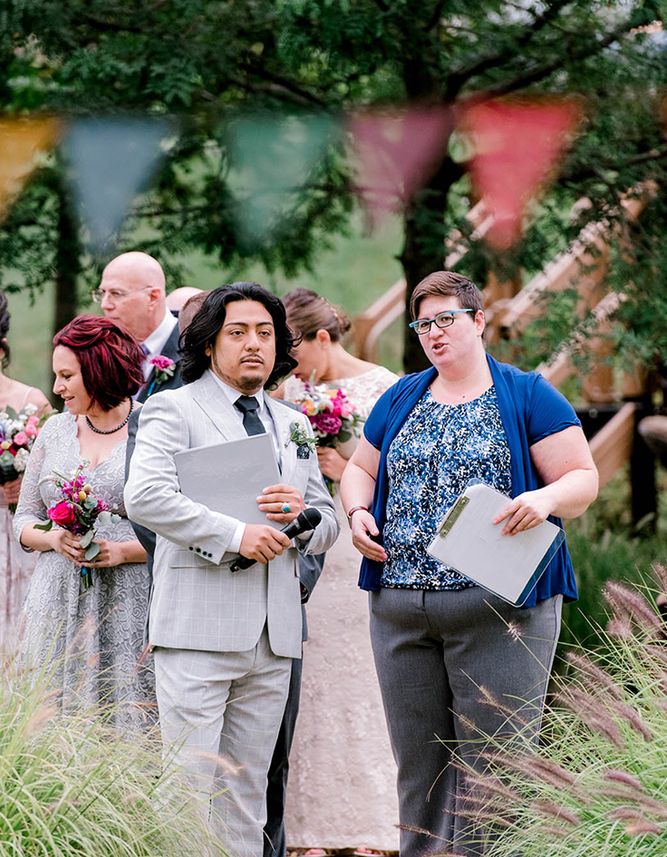 Cindy Savage, wedding planner in Seattle, standing with man in suit at queer wedding