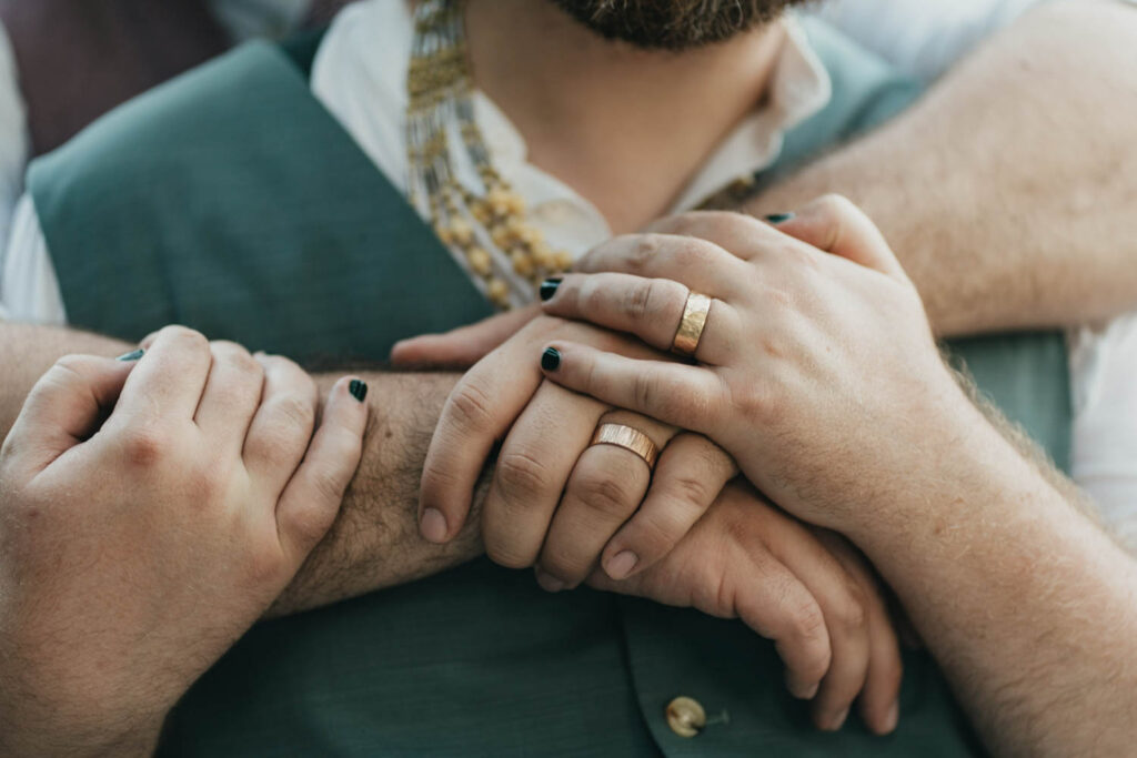 Grooms hugging each other during wedding in Seattle