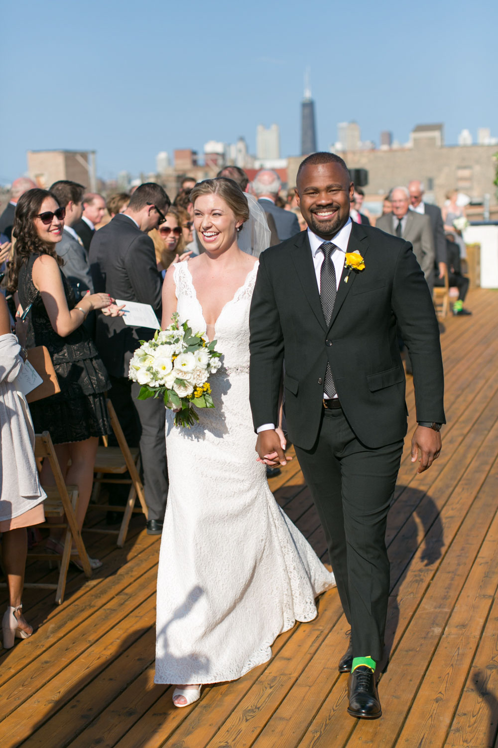 bride and groom walking down aisle in seattle skyline