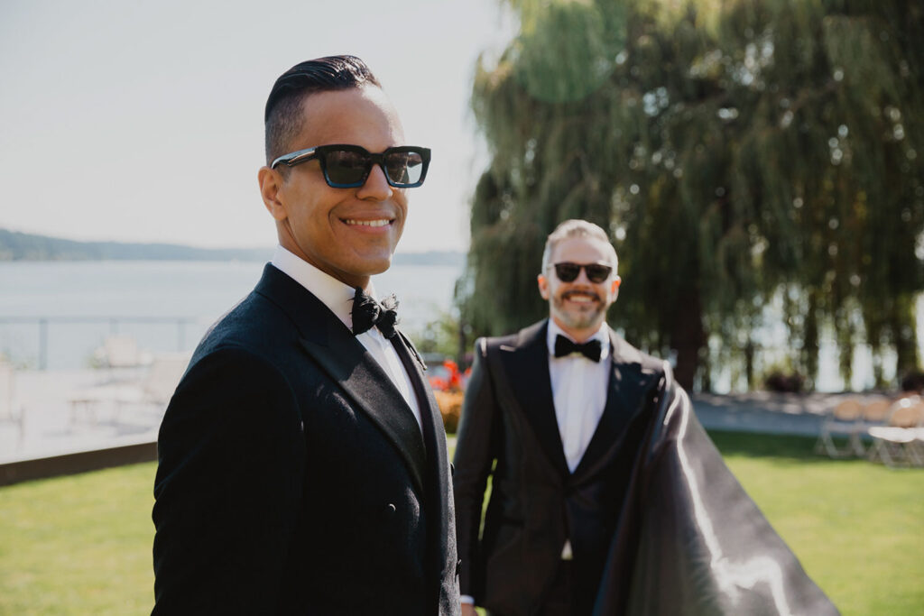 Andy and Victor standing together on their wedding day in sunglasses