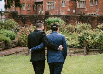 grooms walking together at wedding venue