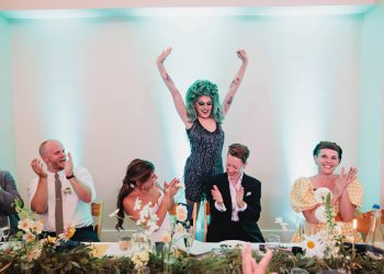 drag queen dancing with Jackie and Tracey at their head table on their wedding day