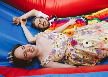 bride and groom laying together in bouncy house