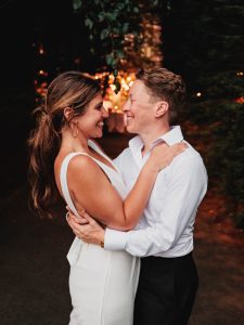 Jackie and Tracey smiling at each other on their wedding day