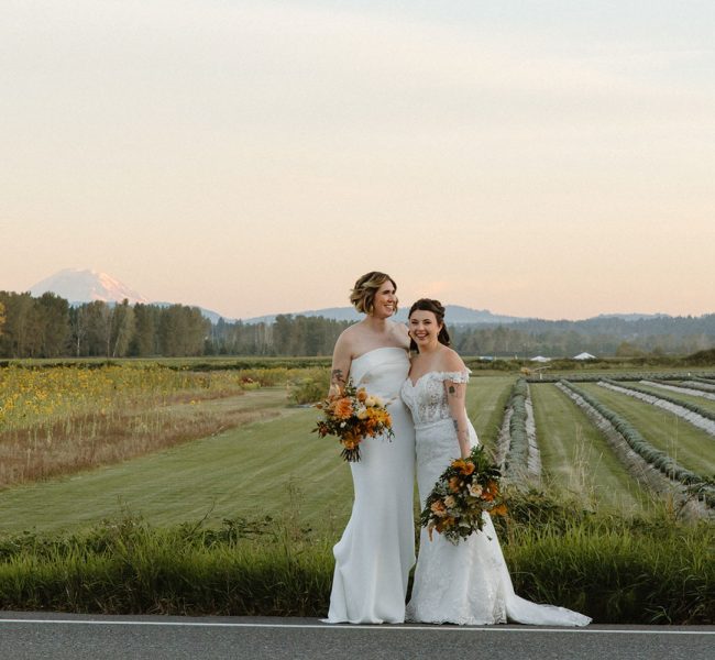 Steph and Lauren standing in front of a field at Willows Lodge, WA