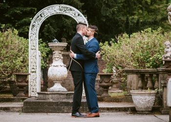 grooms kissing at wedding ceremony in Seattle