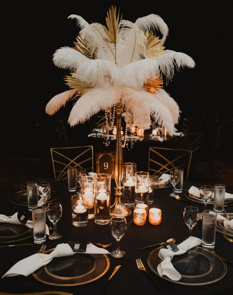 luxury tablescape design with feathers and leaves and floating candles